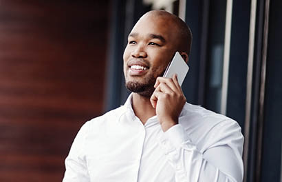 Shot of a handsome young businessman talking on a cellphone outside his office