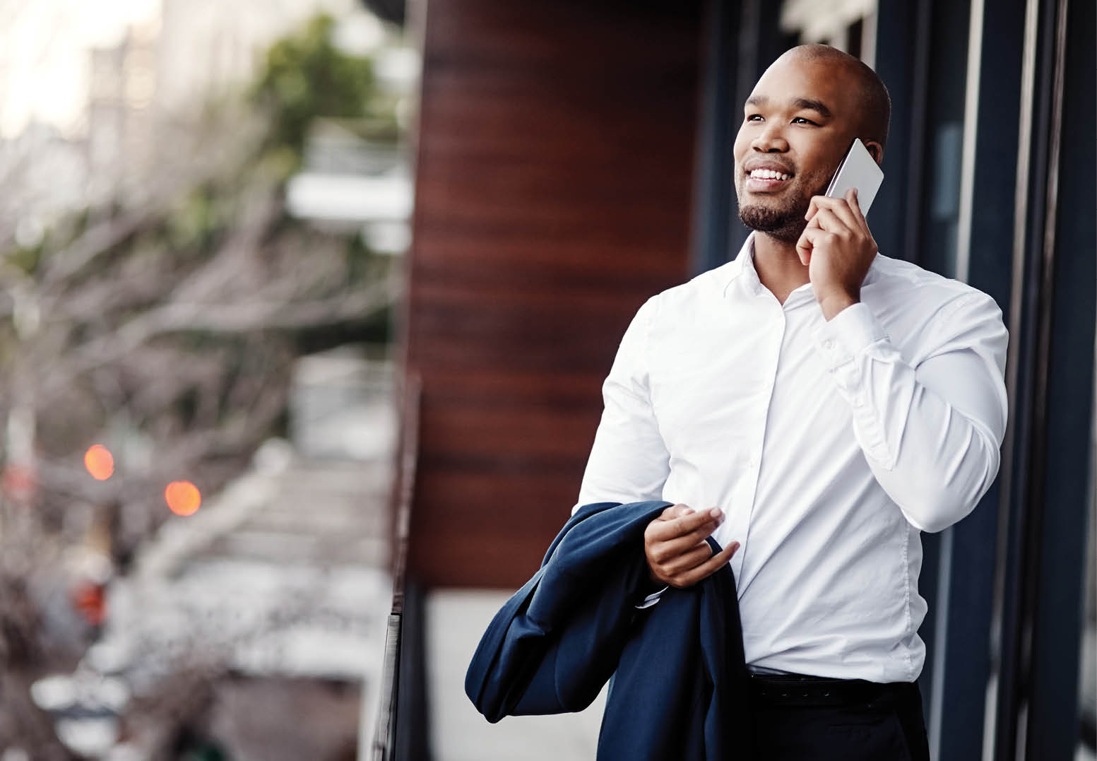 Shot of a handsome young businessman talking on a cellphone outside his office
