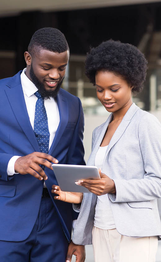 Dark-skinned business people using digital tablet and discussing new project details outdoors