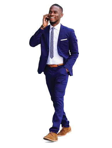 Full length portrait of a happy young businessman walking in the city and talking on mobile phone