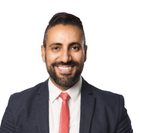 An attractive businessman wearing a blue suit with a red tie, holding a clipboard  Toothy smile standing against a white background 
