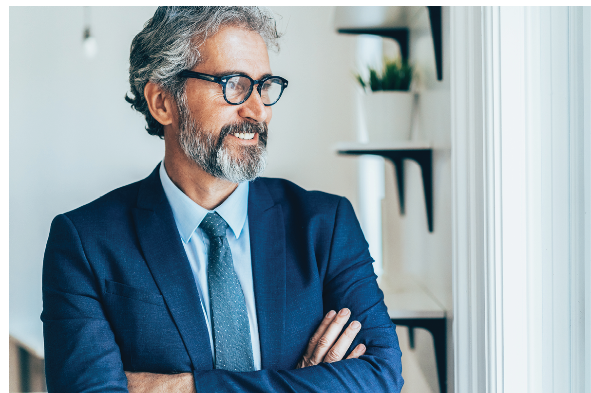 Portrait of Confident and smiling businessman with arms crossed