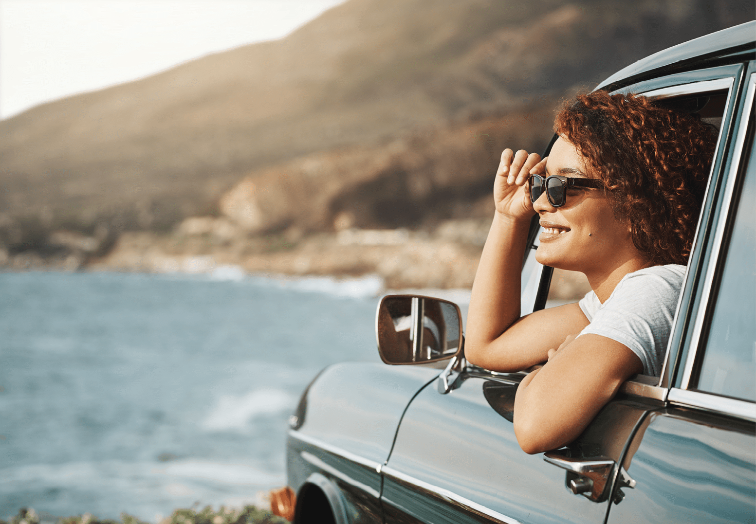 Shot of a young woman enjoying a road trip