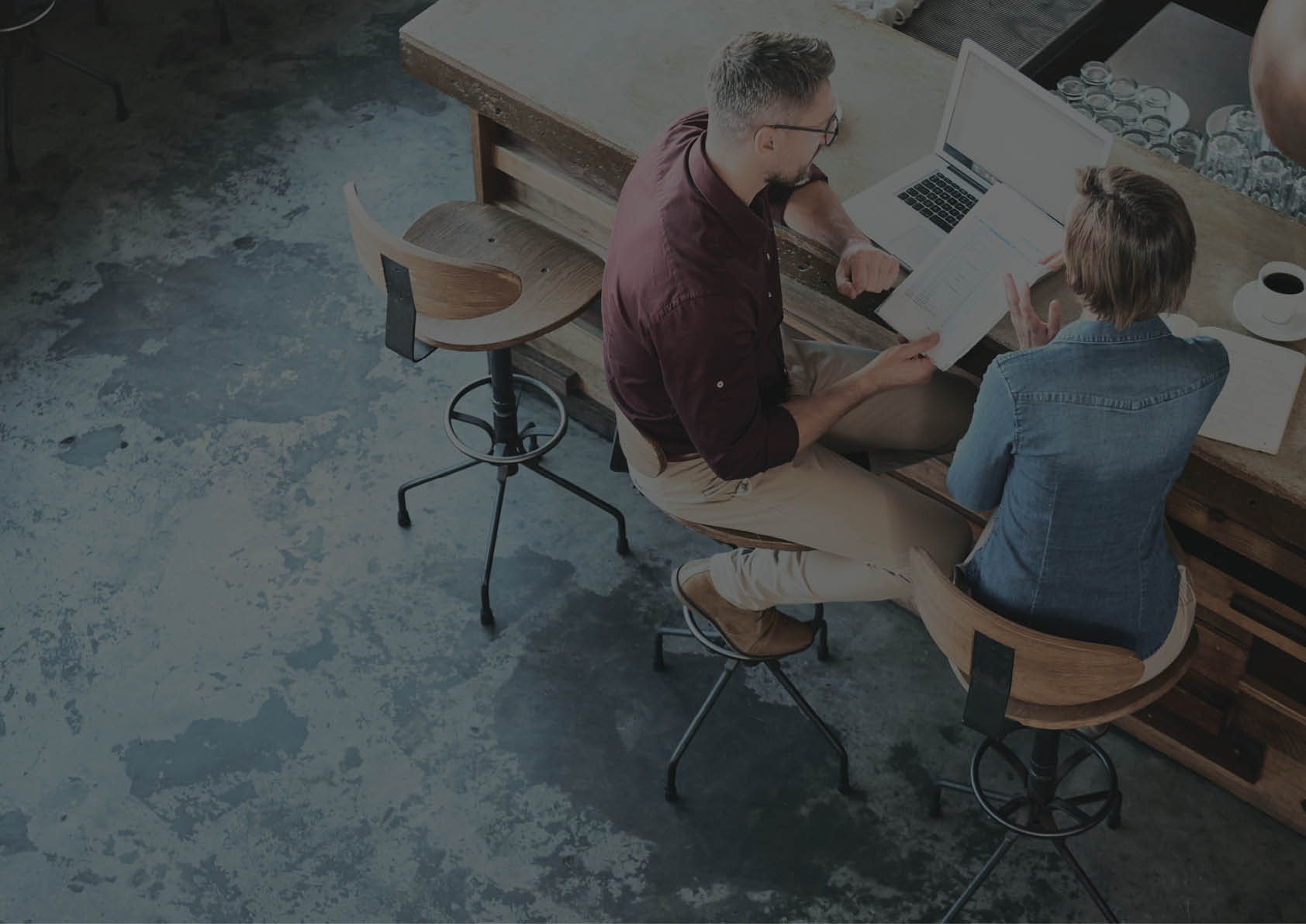 High angle shot of two businesspeople working at the bar in a cafe