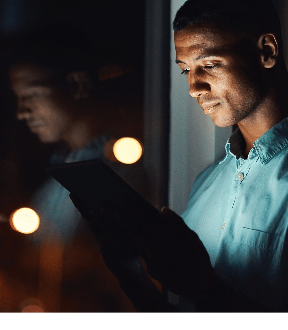 Shot of a handsome young businessman using a digital tablet while working late in his office