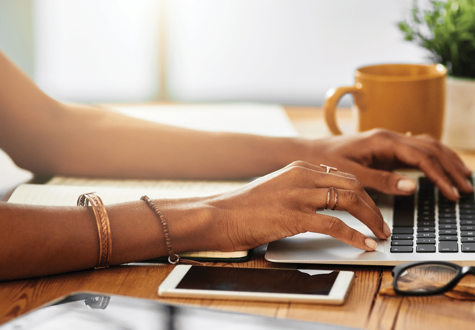 Shot of an unrecognizable woman working from home