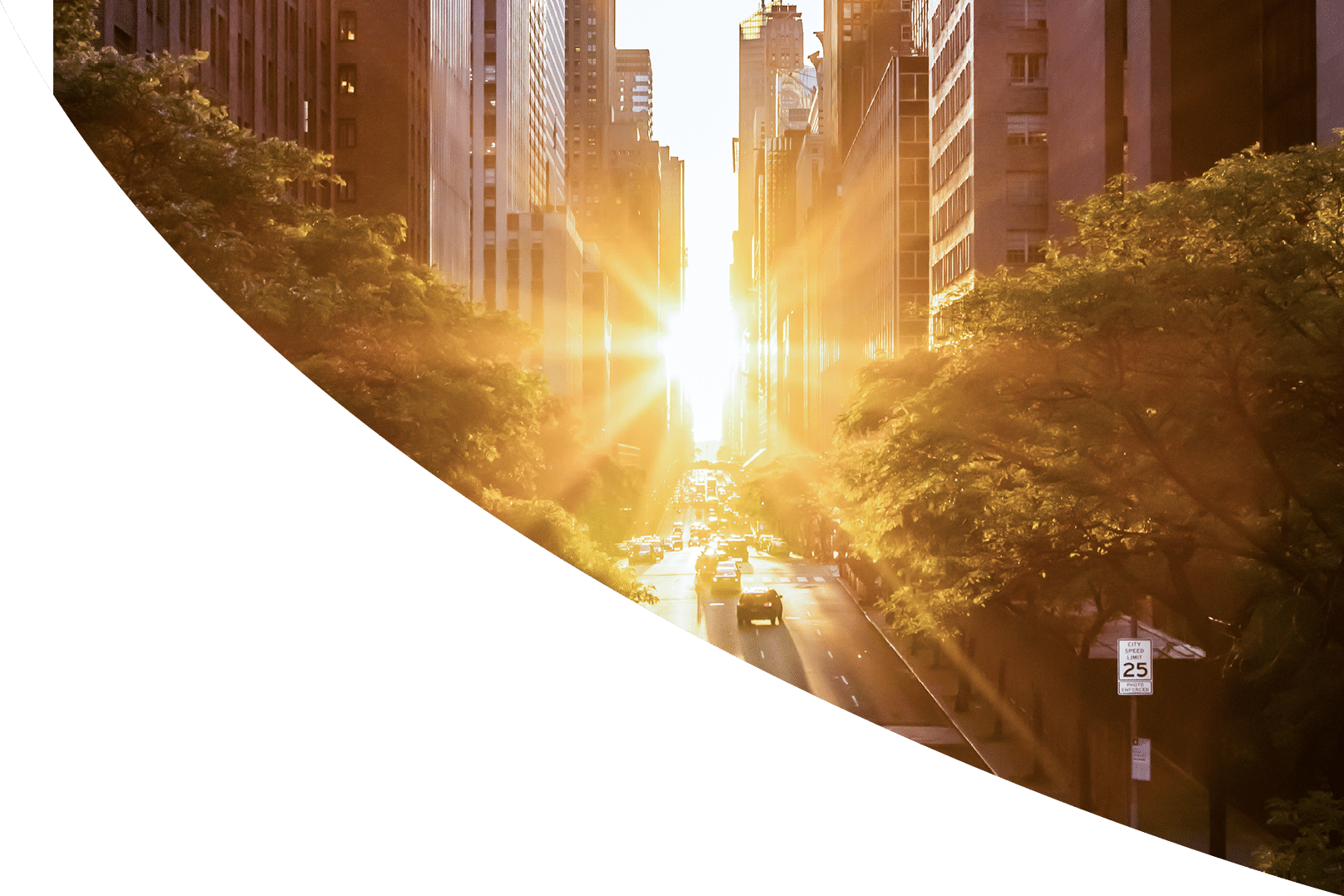 Sunset light shining on the buildings and cars on 42nd Street in Midtown New York City around the time of the Manhattanhenge summer solstice