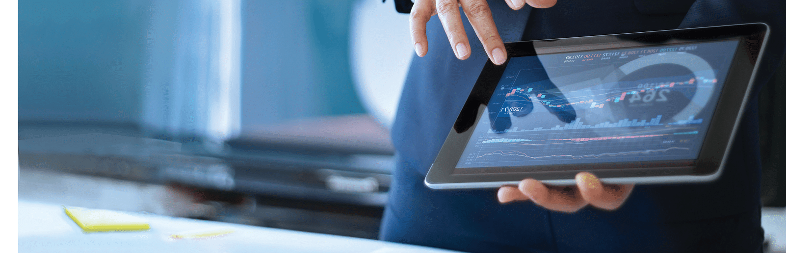 Analyzing data, Businessman working and checking market data in office, hand pointing on the data presented in the chart on tablet